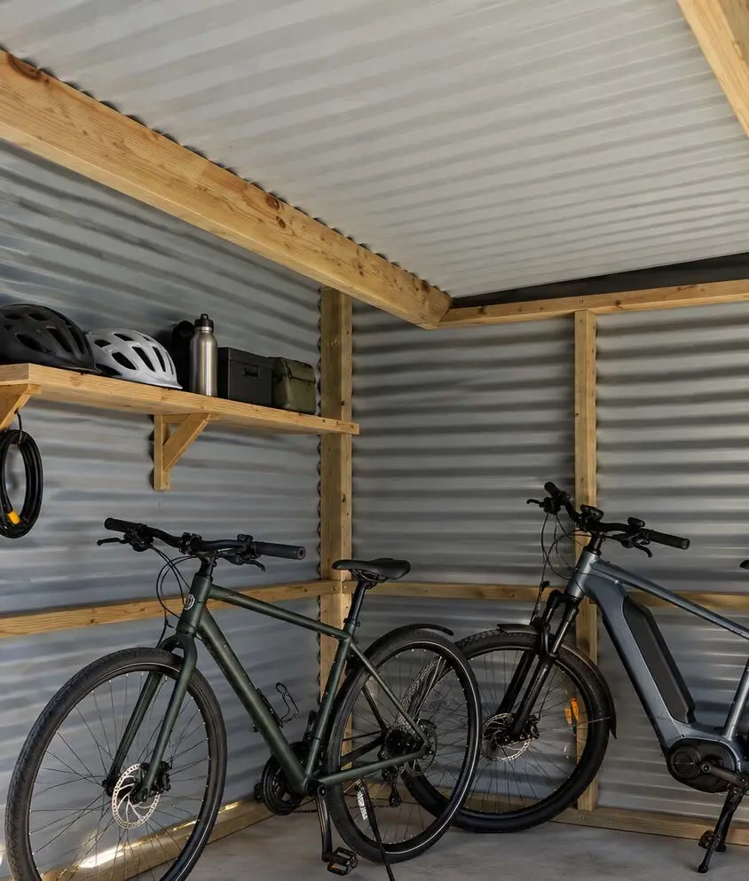 Bikes and helmets stored inside a timber-framed shed